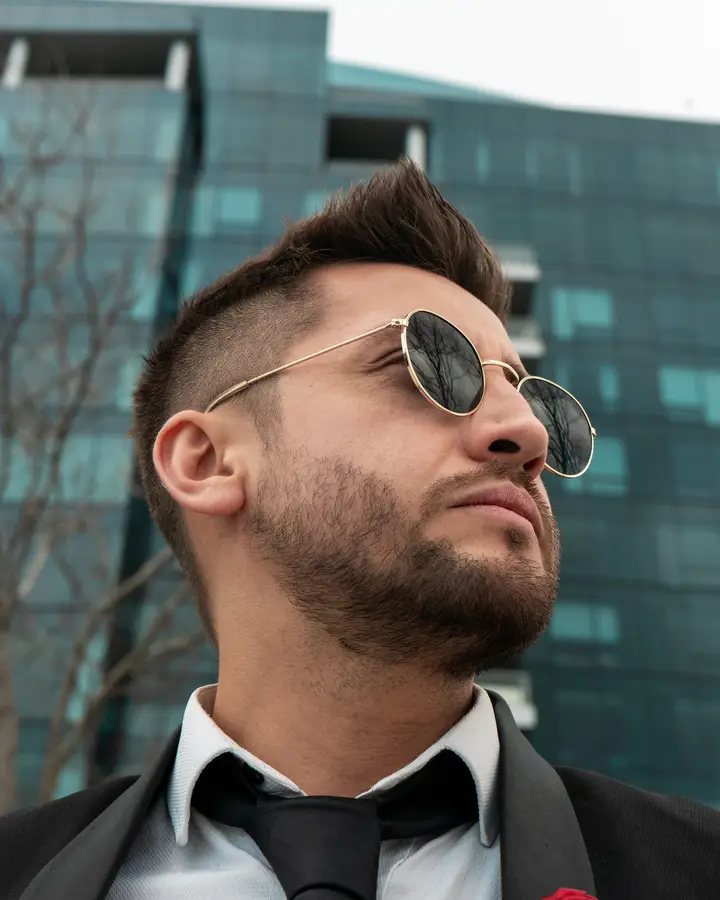 Nicko Guerrero looking up at a glass building