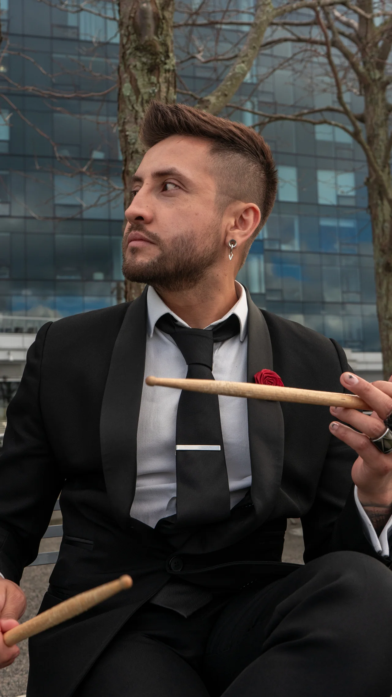 Nicko Guerrero holding drumsticks in Boston